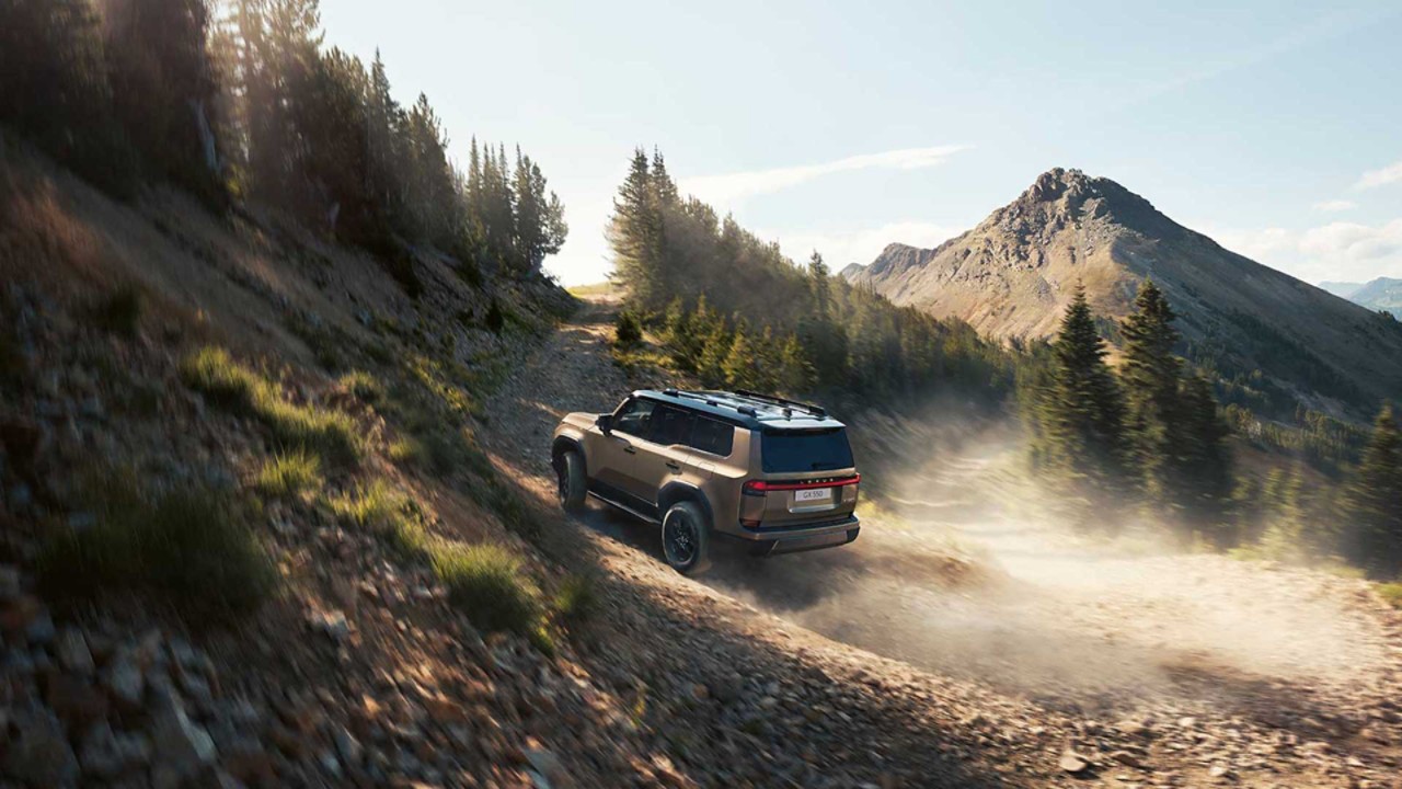 The Lexus GX driving up a steep hill